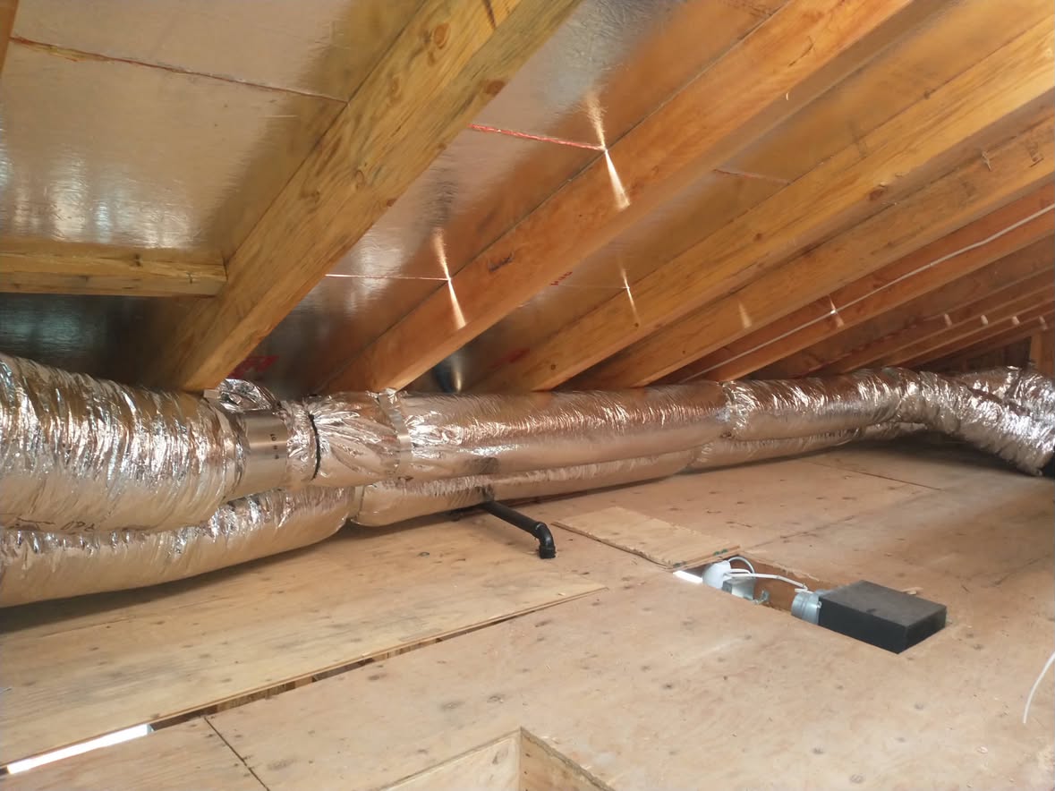 New insulated flex duct trunk run neatly through an attic