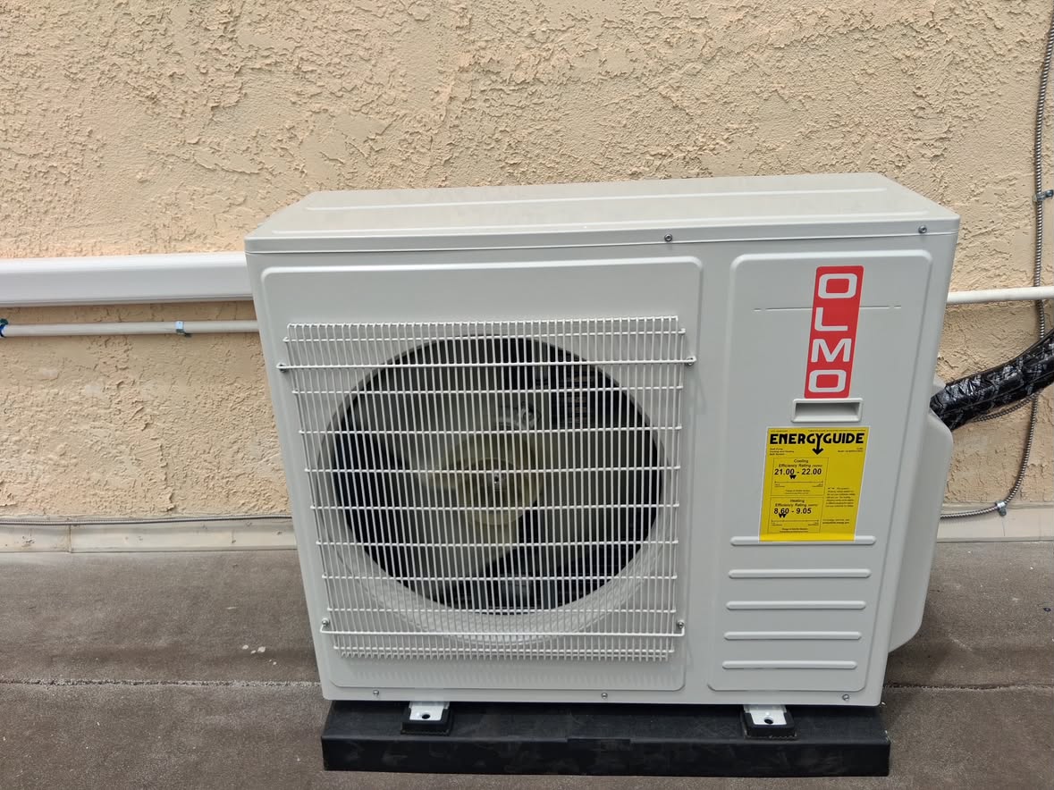 Olmo outdoor mini-split condenser on an isolation pad